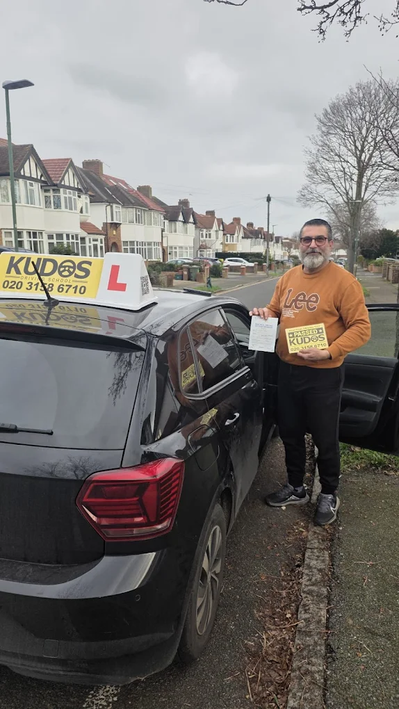 Student showing his licence to the camera with a big smile after months of lessons